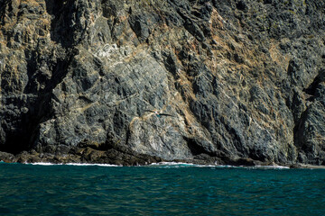 Landscape from the sea of Marguerite island coast over the pacific ocean volcanic rocks in baja...