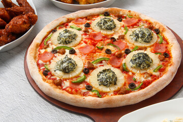 Freshly cooked Pizza with assorted toppings