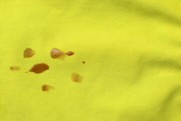 Stains of jam on green fabric, top view