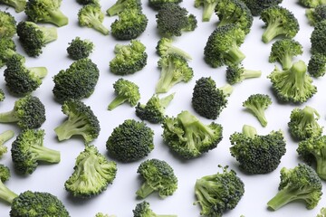 Many fresh green broccoli pieces on white background