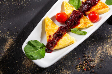 Grilled papialpa cheese with red fruit jam with cherry tomatoes and basil
