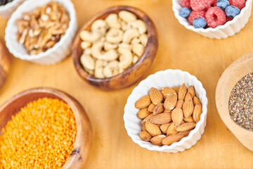 almonds and lentils near assortment of wholesome plant-based food in bowls, vegetarian concept