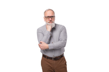 modern smart gray-haired mature businessman with a beard and mustache in a shirt and trousers on a...