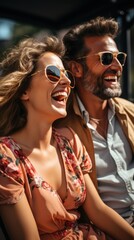 Happy young couple in sunglasses looking and laugh while sitting on bus, vertical.