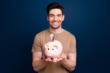 Photo of glad wealthy man wear trendy clothes hold piggy bank collect money for luxurious future...
