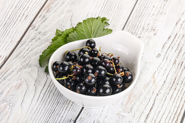 Juicy black currant berries in the bowl