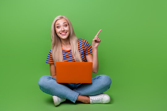 Full length photo of woman wear t shirt point finger banner promoting non code website constructor isolated on green color background - Powered by Adobe