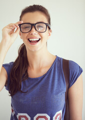 Portrait, student or woman with glasses, funny or happiness on white studio background. Smile, girl or person with eyewear, university or casual outfit with clear vision, mockup space or prescription