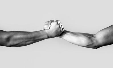 Two hands, helping arm of a friend, teamwork. Friendly handshake, friends greeting, teamwork,...