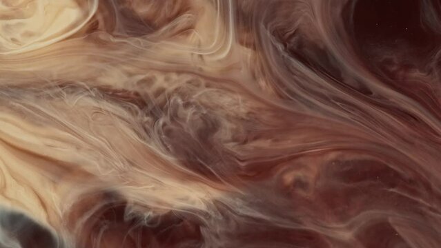 Video of fluid art painting, featuring an abstract acrylic texture with a flowing effect. Mocha mousse color of the year 2025.