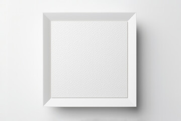 Empty white square photo frame with patterned surface on minimal light wall background. Mock up template advertisement concept