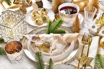 Christmas Eve table with white and gold color decoration and red