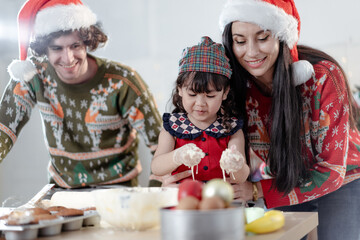 Kid mom daddy family celebrating xmas Christmas thanksgiving in dining room enjoy kneading cake dough together. People enjoy celebrate Christmastime festive with yummy good taste food drink joy party