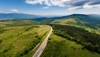 Fototapeta na wymiar aerial view of countryside road passing through the green forest and mountain aerial view over mountain road going through forest landscape