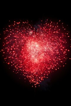 photo of fireworks in the shape of a heart, ideal for Valentine's Day or wedding-related promotions