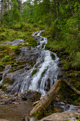 Wide waterfall buried in moss