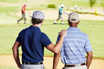 Fitness, golf and athletes in discussion on field writing notes for competition or tournament strategy. Sports, smile and professional happy male players talking for hobby on an outdoor course.