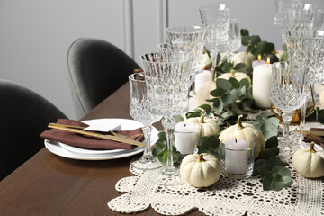 Beautiful autumn table setting. Plates, cutlery, glasses and floral decor