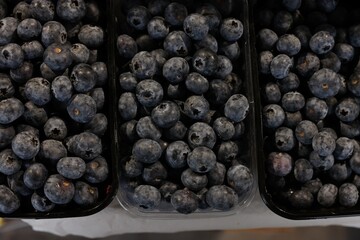 Many fresh blueberries on counter at market, top view