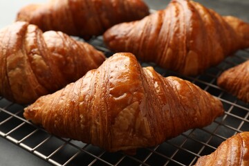 Delicious fresh croissants on grey table, closeup