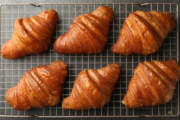 Delicious fresh croissants on grey table, flat lay