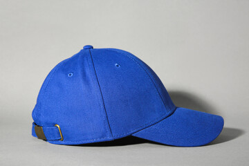 Stylish blue baseball cap on grey background