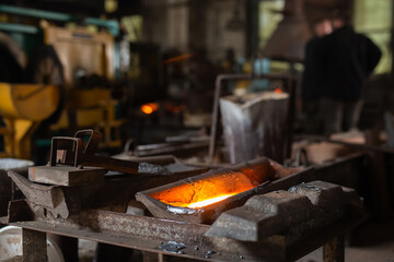 Mold with molten metal in the foundry workshop of metallurgical plant