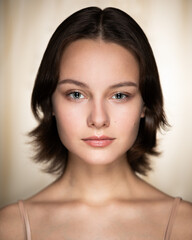Beauty portrait of teen girl against beige background