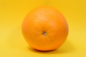 juicy fresh orange on a yellow background