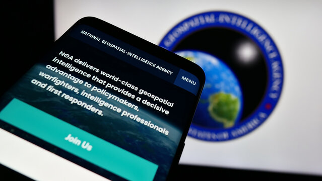Stuttgart, Germany - 11-11-2023: Smartphone with website of US National Geospatial-Intelligence Agency (NGA) in front of seal. Focus on top-left of phone display.