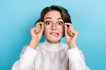 Photo portrait of attractive young woman bite lips excited touch eyewear wear trendy white clothes isolated on blue color background