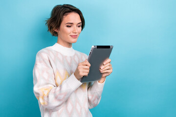 Photo portrait of attractive young woman hold tablet reading ebook dressed stylish white clothes isolated on blue color background