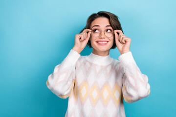 Photo portrait of attractive young woman touch specs look empty space dressed stylish white clothes isolated on blue color background