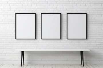 Three wooden frames with a pictures or photos on white brick wall in modern minimalistic home...
