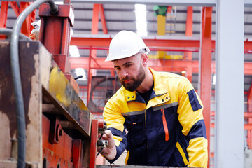 Engineer inspects machinery in industrial plants.