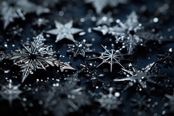  a group of snowflakes sitting on top of a black surface with drops of water on the top and bottom of the snowflakes on the bottom of the snowflakes.
