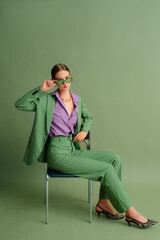  Fashionable beautiful confident woman wearing trendy color sunglasses, suit blazer, classic...
