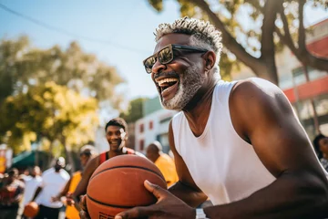 Fotobehang Mature African descent man playing basketball with friends on a sunny urban court conveying energy joy and camaraderie suitable for sports and healthy lifestyle marketing © Made360