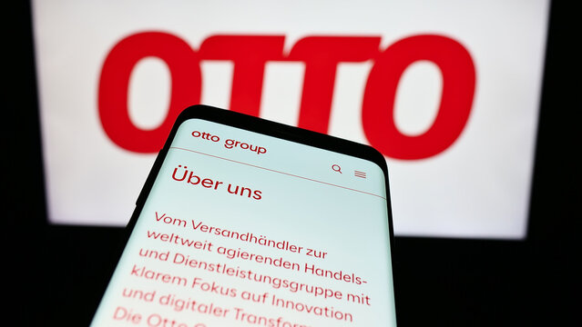 Stuttgart, Germany - 11-14-2023: Smartphone with website of German mail order company Otto GmbH Co KG in front of business logo. Focus on top-left of phone display.