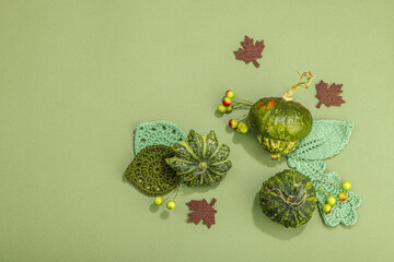 Autumn cozy composition. Crocheted leaves, pumpkins, berries, handmade, fall hobby concept