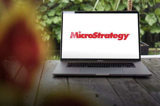 MicroStrategy logo, American company that provides business intelligence (BI), mobile software, and cloud-based services, displayed on MacBook Pro screen