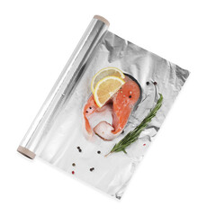 Aluminum foil with raw salmon, lemon slices, rosemary and spices isolated on white, top view