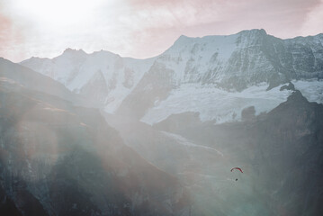 misty mountains with paraglider