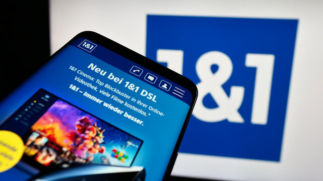 Stuttgart, Germany - 11-15-2023: Mobile phone with website of German company 1und1 Telecommunication SE in front of business logo. Focus on top-left of phone display.