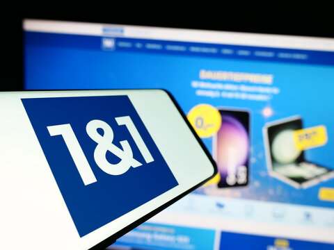 Stuttgart, Germany - 11-15-2023: Smartphone with logo of German company 1und1 Telecommunication SE in front of business website. Focus on center-left of phone display.