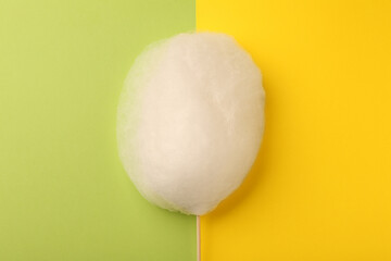 One sweet cotton candy on color background, top view