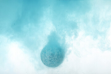 Fototapeta premium Light blue bath bomb dissolving in water