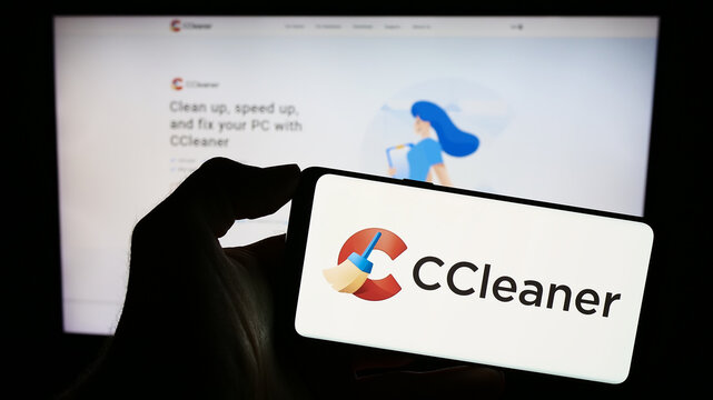 Stuttgart, Germany - 11-15-2023: Person holding mobile phone with logo of computer system clearning software CCleaner in front of business web page. Focus on phone display.