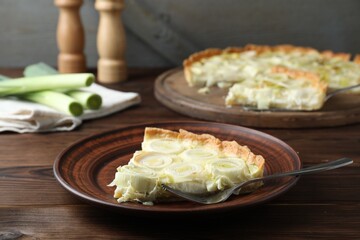 Tasty leek pie served on wooden table