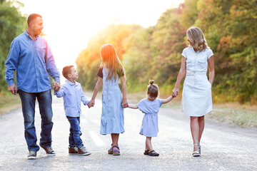 A Happy family walking along the road in the park on nature travel